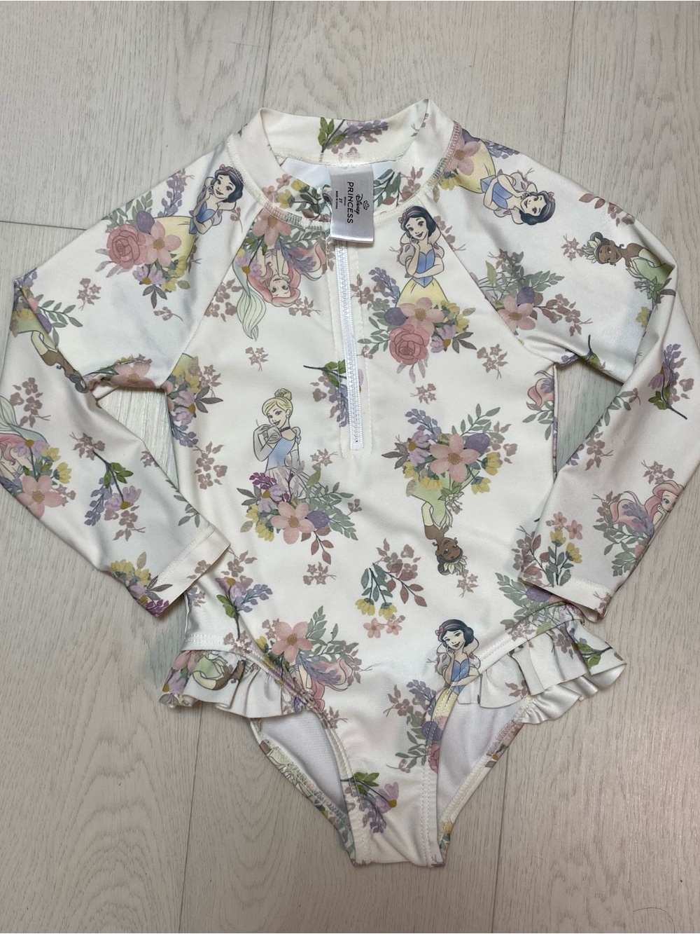 Disney Girls' One-Piece Rash Guard Swimsuit in White with Pastel Floral Print